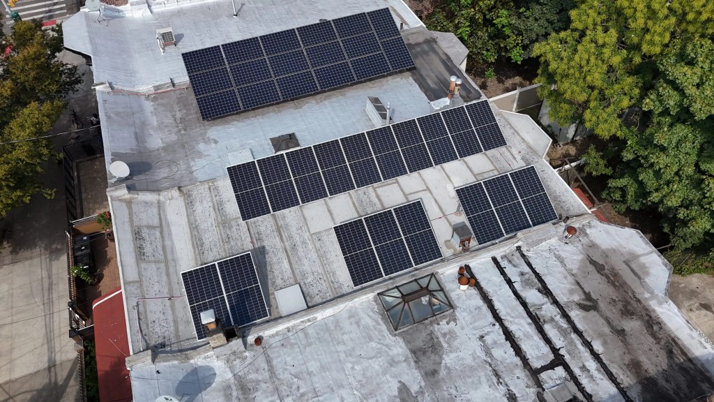 “Aerial view of solar panels on a residential rooftop, photovoltaic system on a flat roof